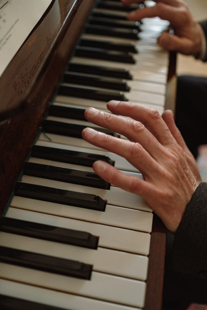 A detailed view of a pianist's hands skillfully playing a piano, showing emotion and artistry.