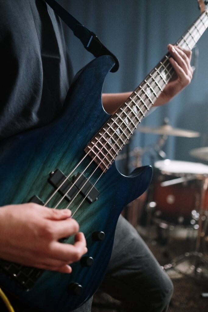 Crafting Captivating Headlines: Your awesome post title goes here Detailed view of a musician playing a blue bass guitar in a sound studio, showcasing musical performance.
